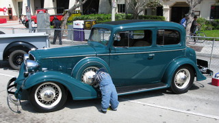 Illustration for article titled Why do car collectors put creepy dolls on their bumpers?